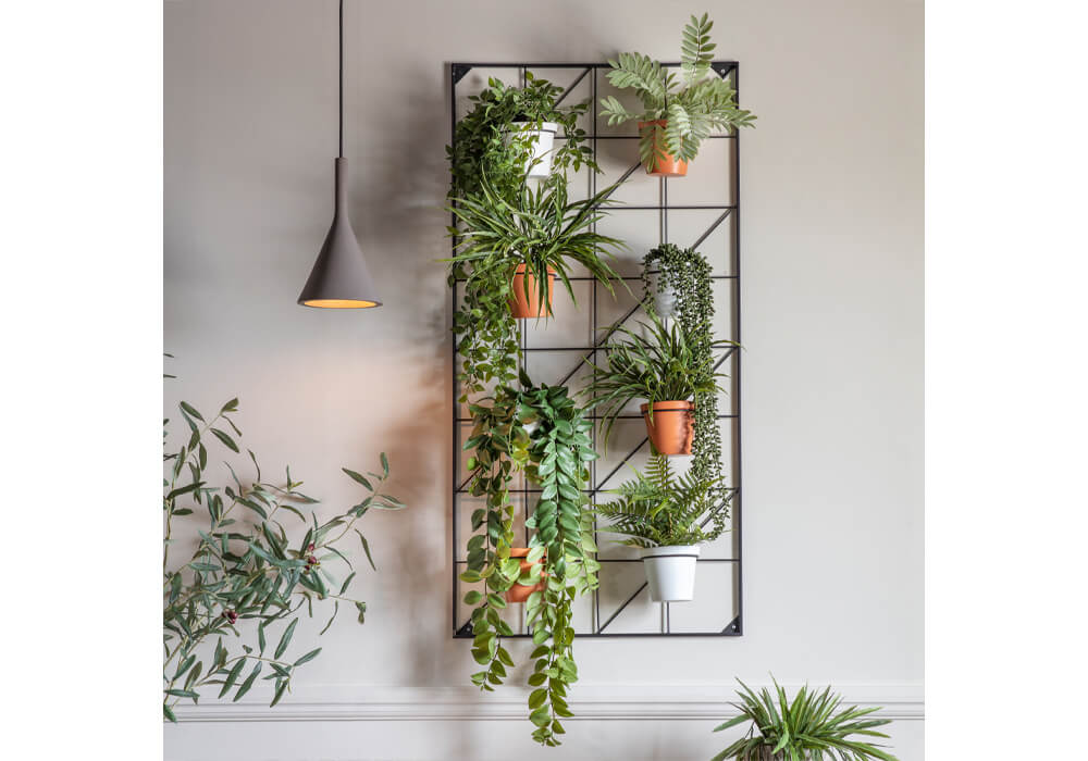 Small Garden Ideas - A rectangular wall mounted metal wall planter with 4 white and 4 terracotta coloured plant pots with draping greenery