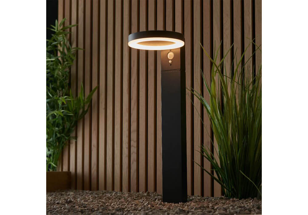 Small Garden Ideas - A halo-style outdoor floor light in a modern garden with slatted wooden wall and gravel pathway